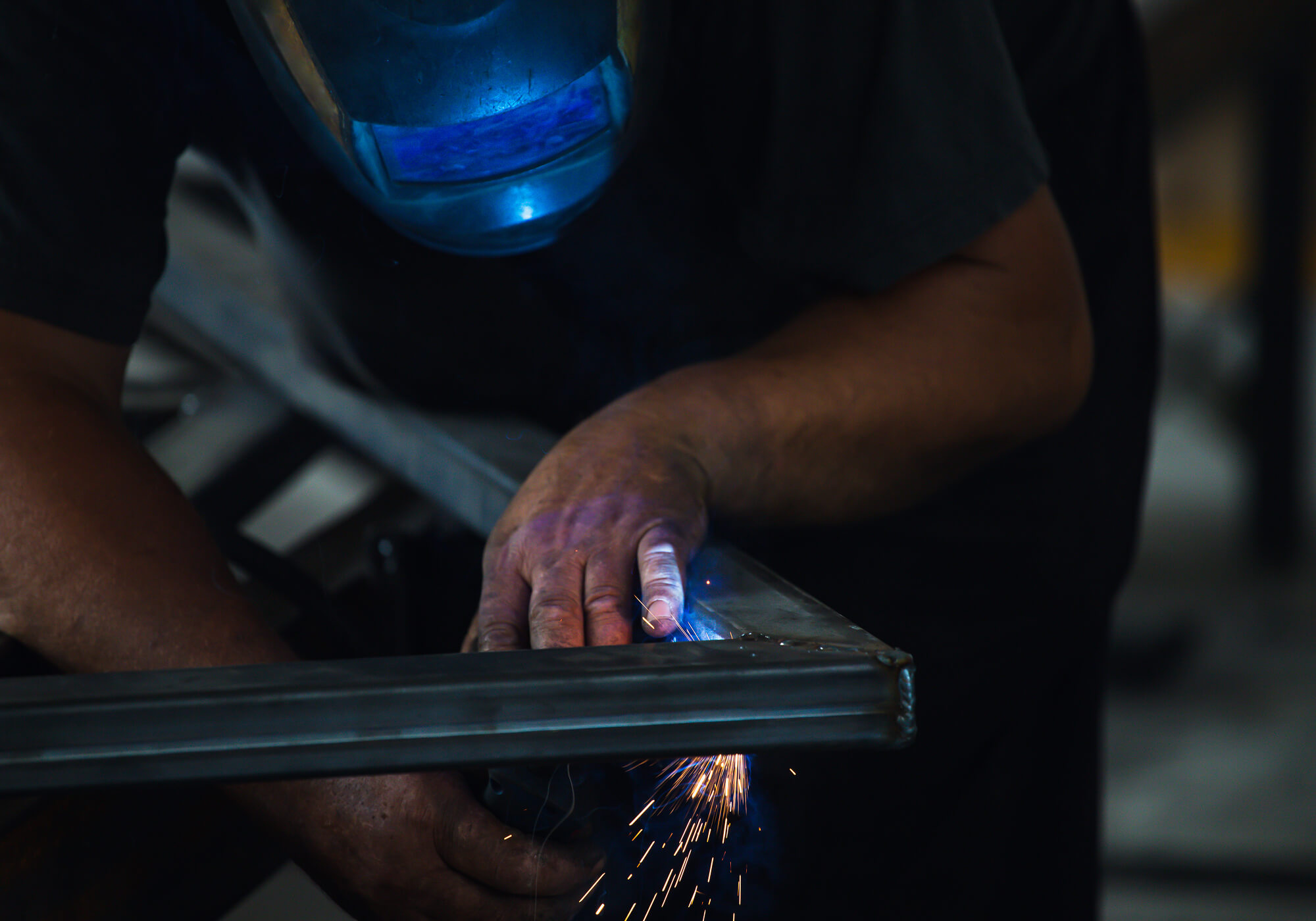 industry-worker-welding-iron-pieces-at-work-TN68MSH